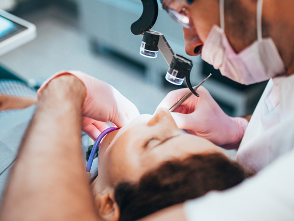 dentist performing dental procedure on patient focused on oral health and treatment